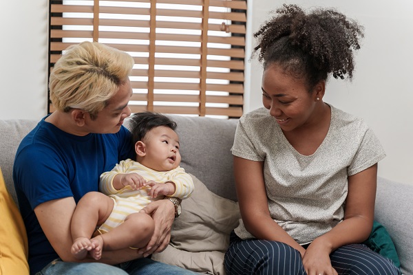 Young man and woman caring for baby